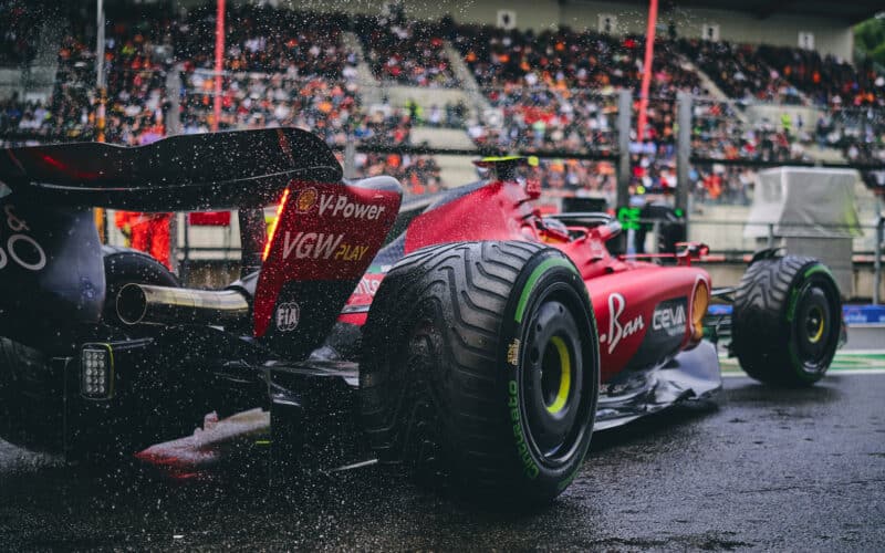 a ferrari f1 race car is parked in front of a crowd