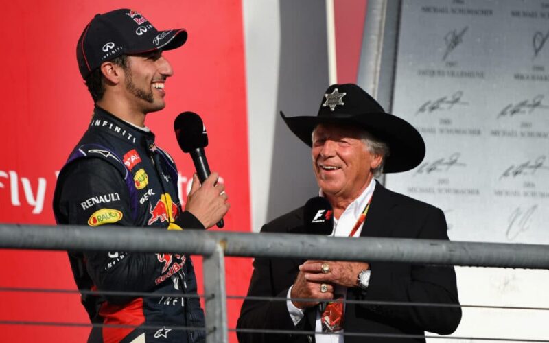 a man in a cowboy hat talking to a man in a suit